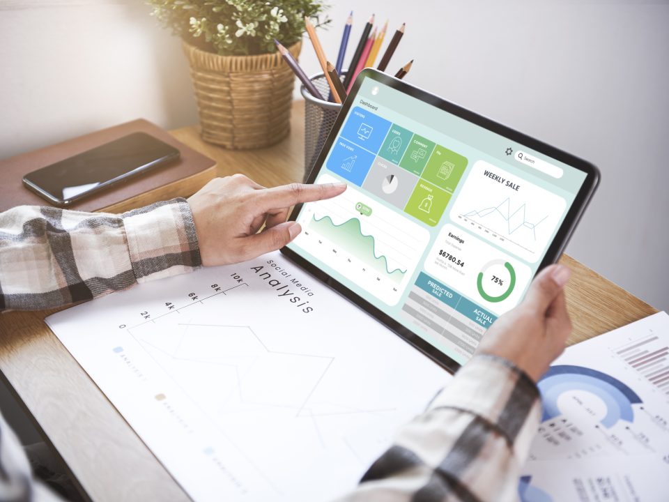 Businesswoman using a tablet to analysis graph company finance s